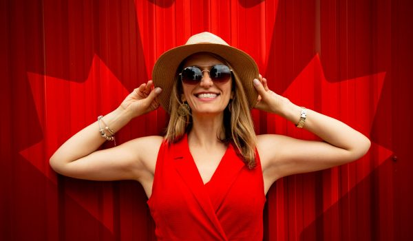 Photo by Andre Furtado: https://www.pexels.com/photo/woman-in-red-sleeveless-dress-with-canada-flag-printed-background-1267369/